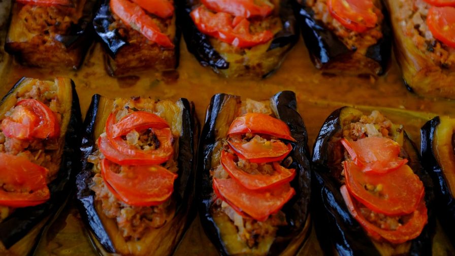 Berenjenas al horno con tomate servidas en una fuente.